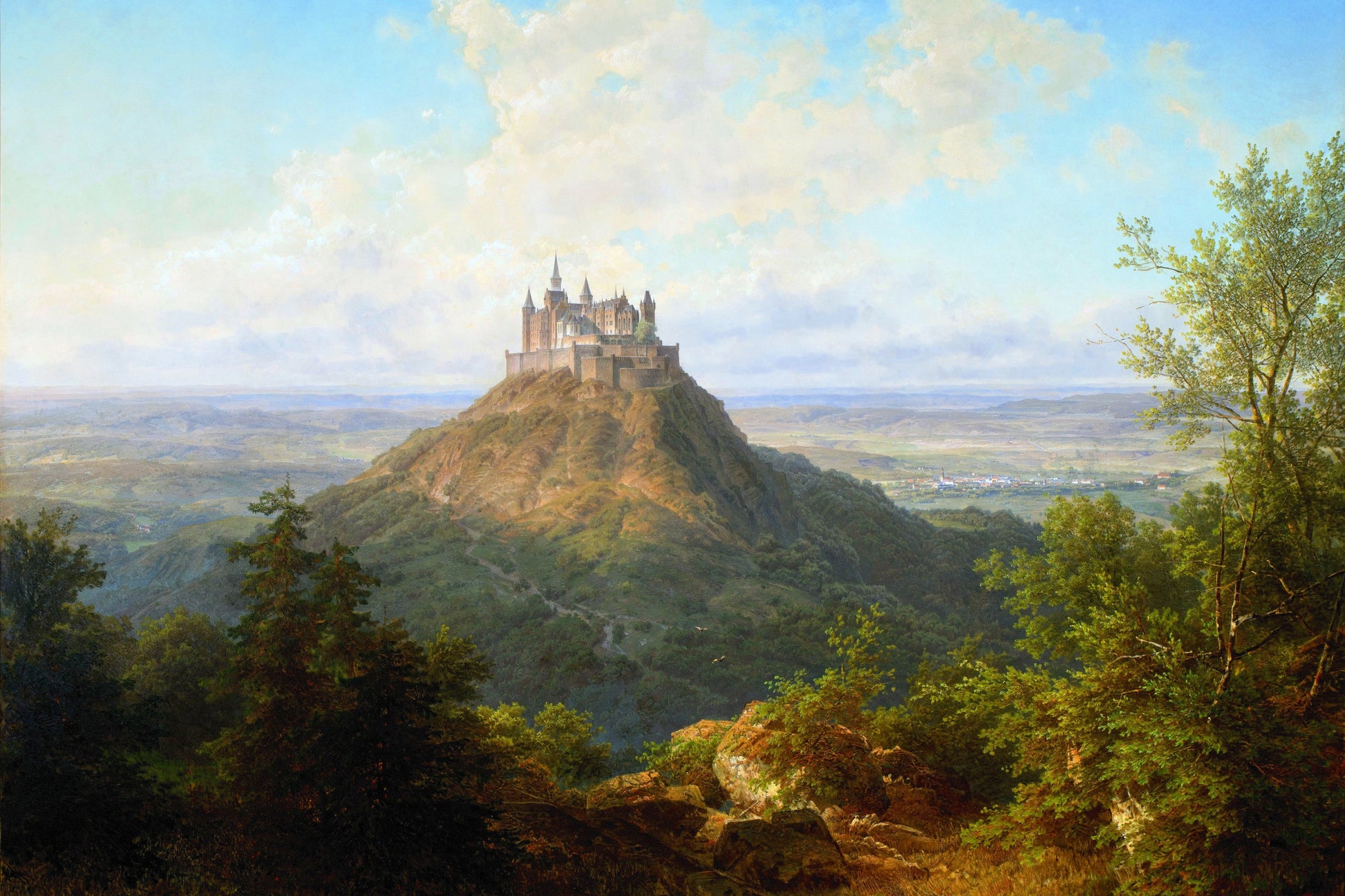 Castle on a hill with a landscape and trees in the foreground