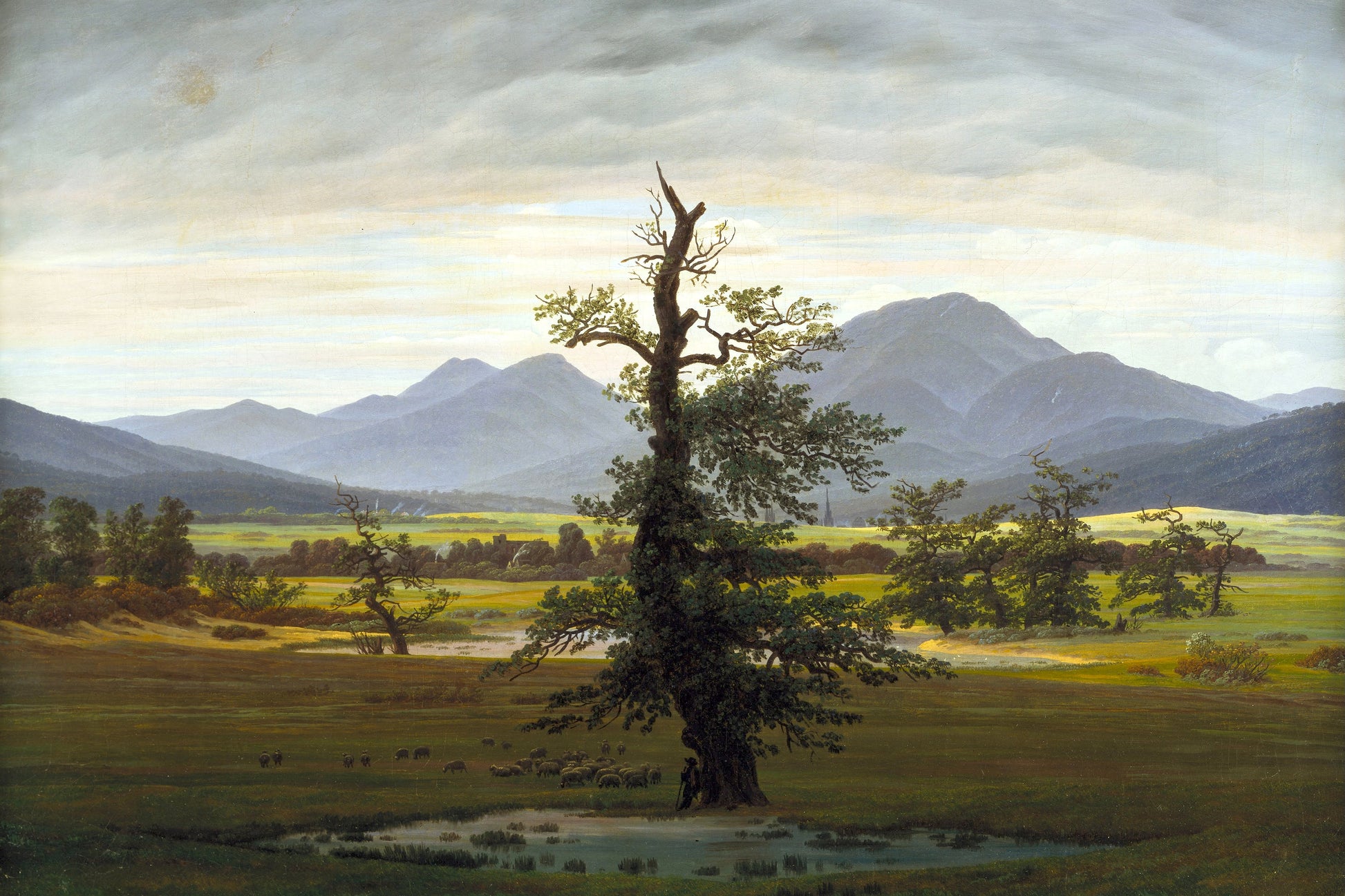 Landscape painting with a lone tree in a field and mountains in the background