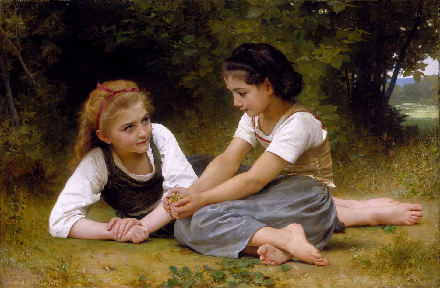 Two young girls sitting on the grass in a natural setting